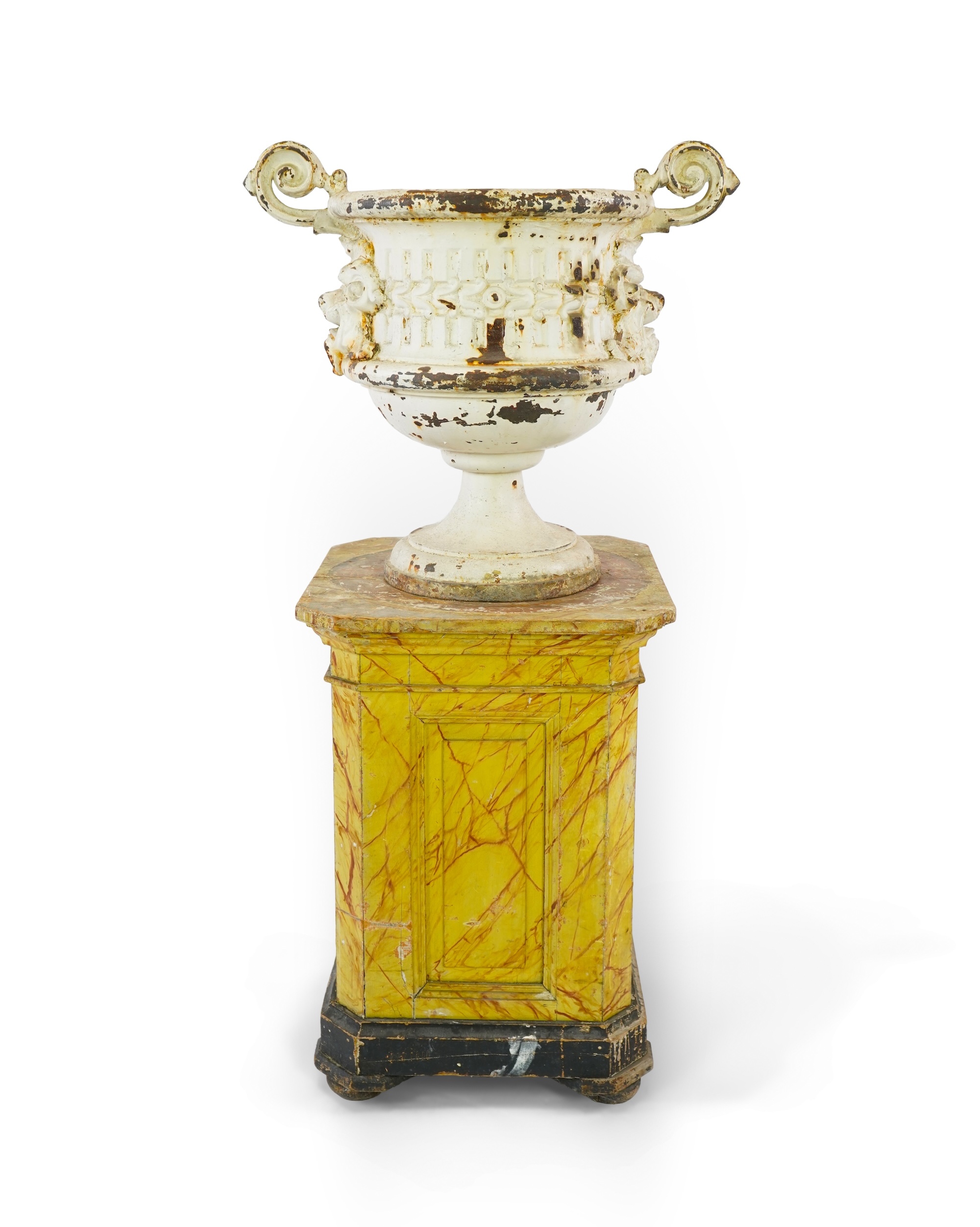 A Victorian white painted cast iron urn and a painted faux marble pedestal